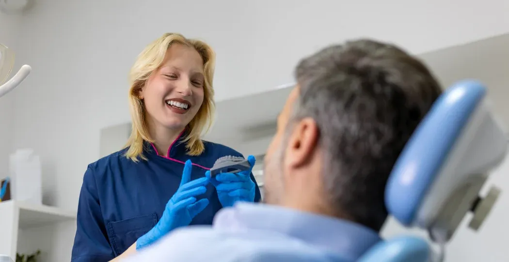 Clinician talking with a patient in the treatment chair